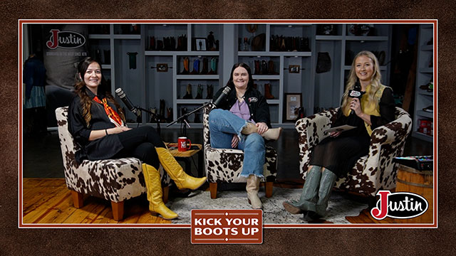 Three women sitting down beside each other, looking at the camera, smiling, sitting, and having a conversation.